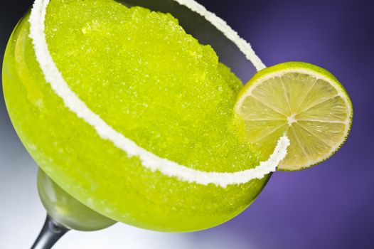 Classic margarita cocktail in front of different colored backgrounds