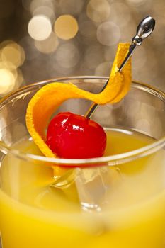 Harvey Wallbanger Cocktail in front of different colored backgrounds