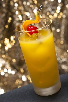 Harvey Wallbanger Cocktail in front of different colored backgrounds