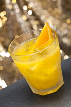 Screwdriver cocktail in front of different colored backgrounds
