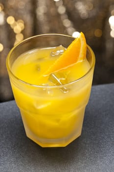 Screwdriver cocktail in front of different colored backgrounds