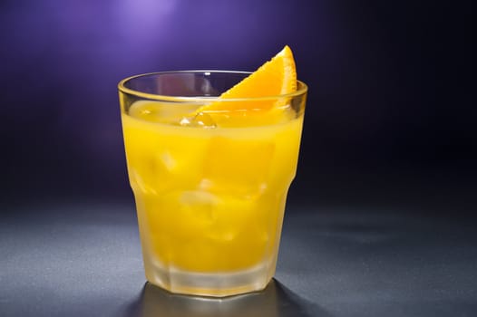 Screwdriver cocktail in front of different colored backgrounds