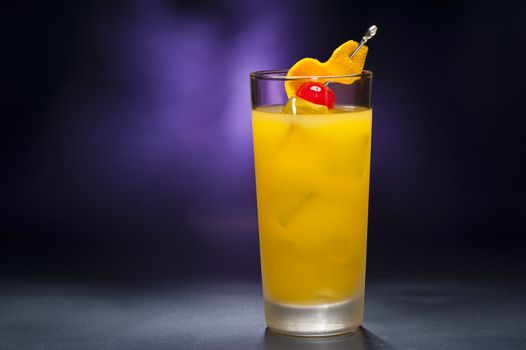 Harvey Wallbanger Cocktail in front of different colored backgrounds