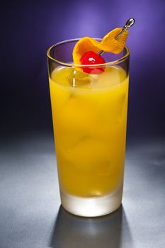 Harvey Wallbanger Cocktail in front of different colored backgrounds