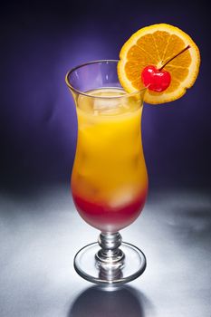 Tequila sunrise Cocktail in front of different colored backgrounds