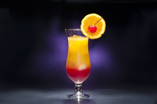 Tequila sunrise Cocktail in front of different colored backgrounds