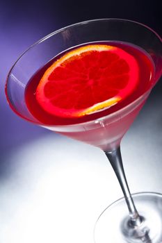 Negroni cocktail in front of different colored backgrounds