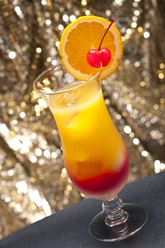 Tequila sunrise Cocktail in front of different colored backgrounds