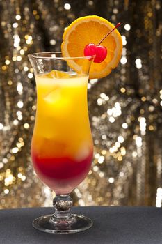 Tequila sunrise Cocktail in front of different colored backgrounds