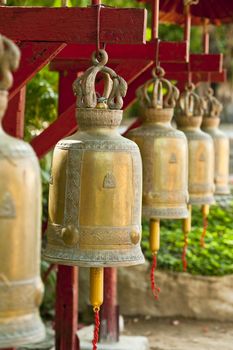 Golden prayer bells in a temple in Thailand