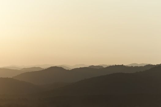 Sunset behind mountains with golden color