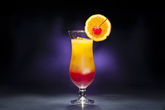 Tequila sunrise Cocktail in front of blue background