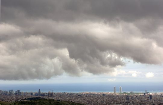 Panoramic view of Barcelona under a stormy sky