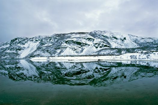The Mountain reflection in a Fjord in Norway above the arctic circle in Winter