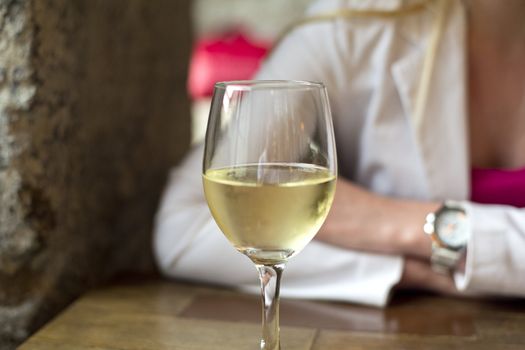 Glass of wine standing on the wooden table