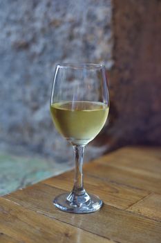 Isolated glass of wine standing on wooden table