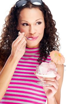 woman eating ice cream decorated with orange umbrella, wearing shirt with pink and gray horizontal stripes, isolated