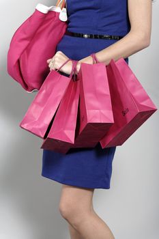 Attractive young woman with lots of shopping bag from a day out shopping.