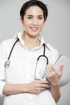 Beautiful young doctor standing with stethoscope