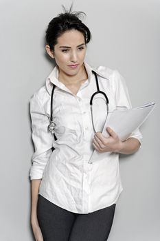 Beautiful young doctor standing with stethoscope