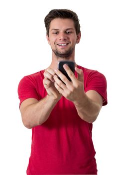 Young White Man In Red T-Shirt Working On His Smartphone