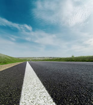 asphalt road closeup to cloudy horizon