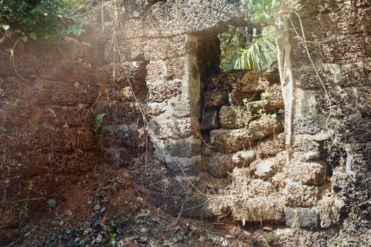 Old stony ruins of the ancient temple in the jungle of India. Horizontal photo with sunlight