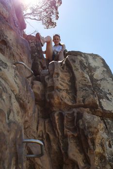 Woman climbing up lions head, cape town, south africa