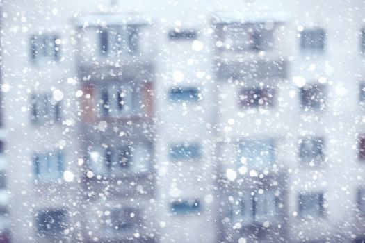 Abstract photo of the snowstorm and residential building on a background