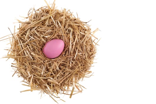 Straw nest with nice colored Easter eggs over white studio shoot