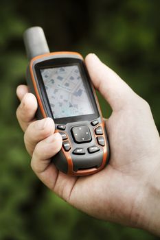 Man holding a GPS receiver in his hand. Handheld GPS devices are used predominantly in the outdoor leisure industry for walking and hiking. 