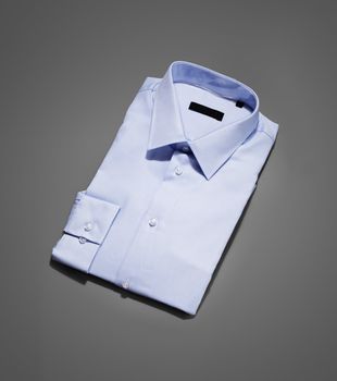 Men's new blue dress shirt on grey background.