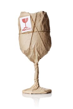 A Wine glass packaged in brown wrapping paper with "Fragile" warning sticker.