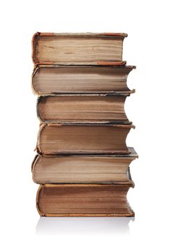 A Stack of old yellowed antique books isolated on white with natural reflection.