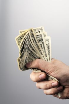 Man holding old US dollars in his hand.