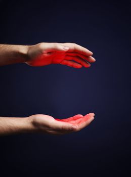 Hands of a man with a red glow.