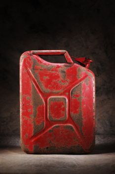 Old red and rusty jerry can gasoline container.
