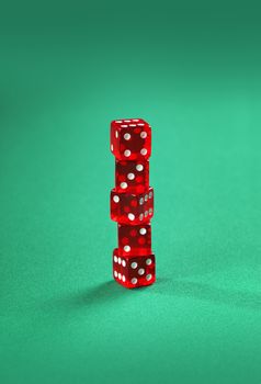 Five red dice stacked on green.