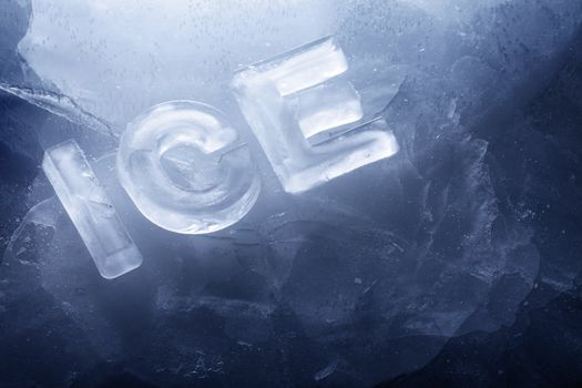 Word "ICE" made with real ice letters on ice.