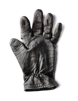 Old worn black leather glove isolated on white with natural shadow.