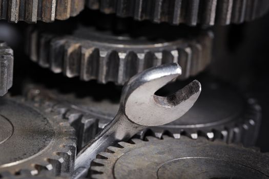 A Spanner Wrench stuck between cog gear wheels.