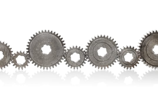 Old metallic cog gears arranged in a row.