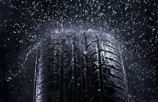 Car tire in rain.