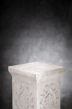 A Plaster column with nothing on its top.
