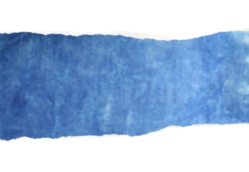 A Torn white paper reveals blue background.