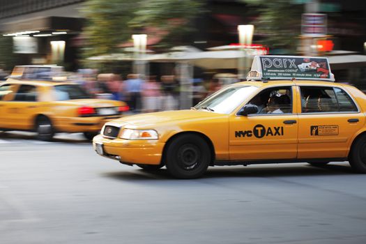 NEW YORK CITY, USA - JUNE 8: Yellow New York taxi cab driving on a street. June 8, 2012 in New York City, USA