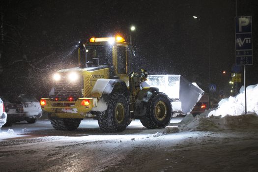 A Front Loader working in snow storm, Finland.