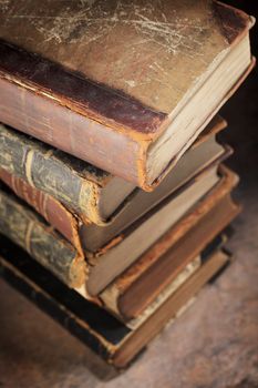 A Stack of old worn and tattered books. Short depth-of-field.