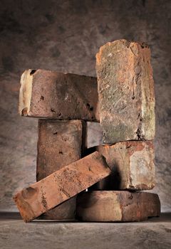 Still life made of old worn and weathered red bricks.