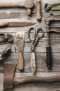 Old rusty tools on wooden background